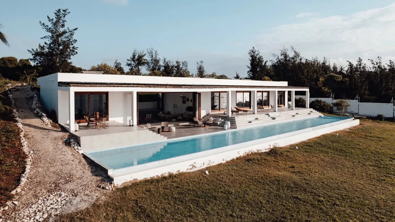 Elegant villa with an infinity pool set in a serene outdoor landscape.
