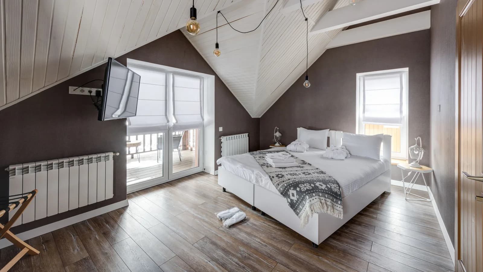 Stylish attic bedroom interior with modern furnishings and a cozy atmosphere.