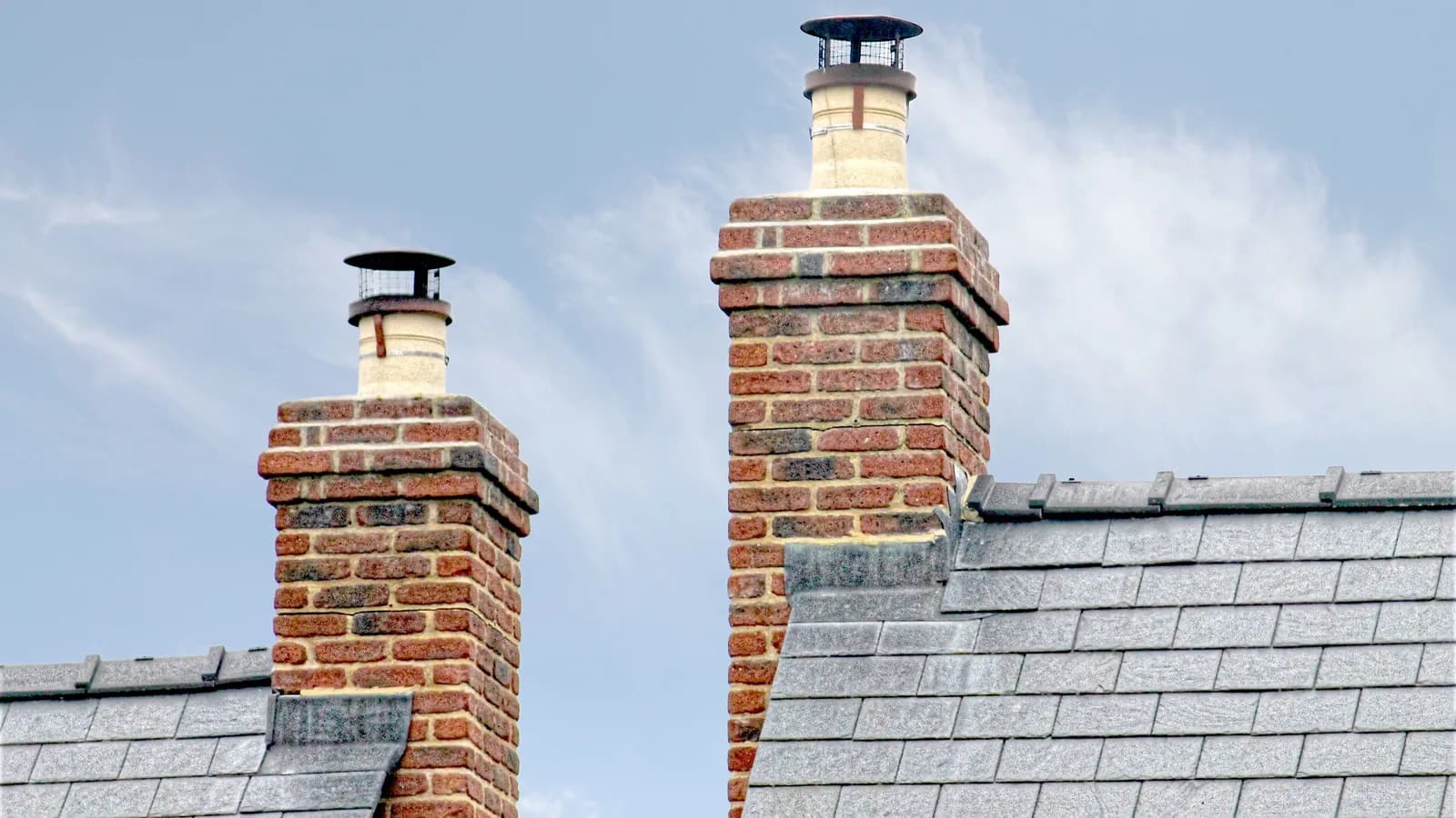 Close-up of traditional brick chimneys on a slate roof, England.