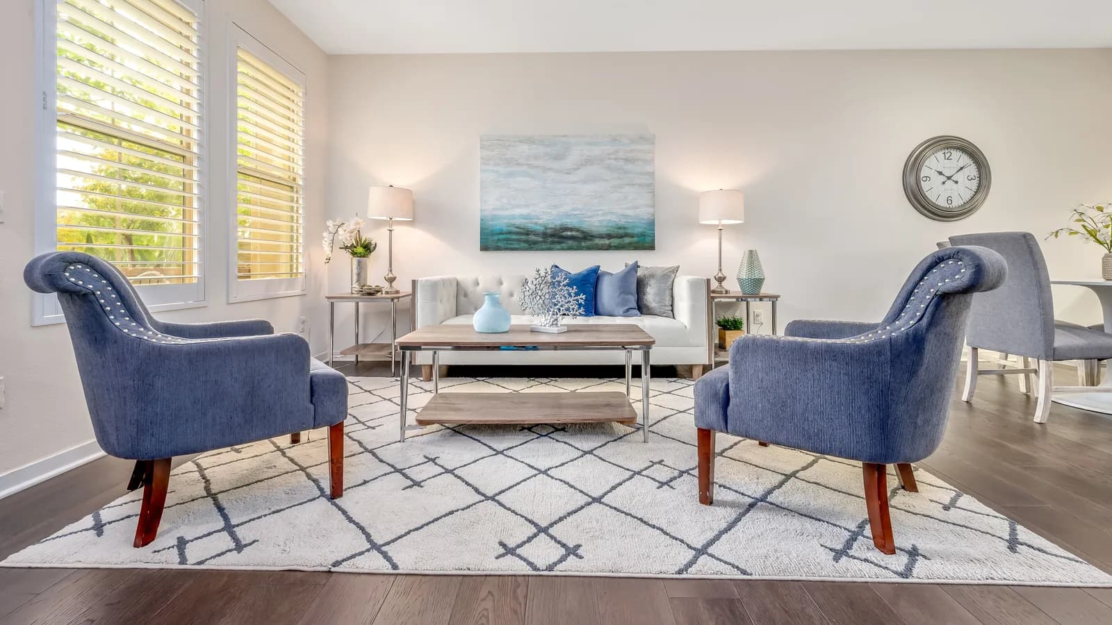 Living room seating group arranged with the front legs resting on a large area rug