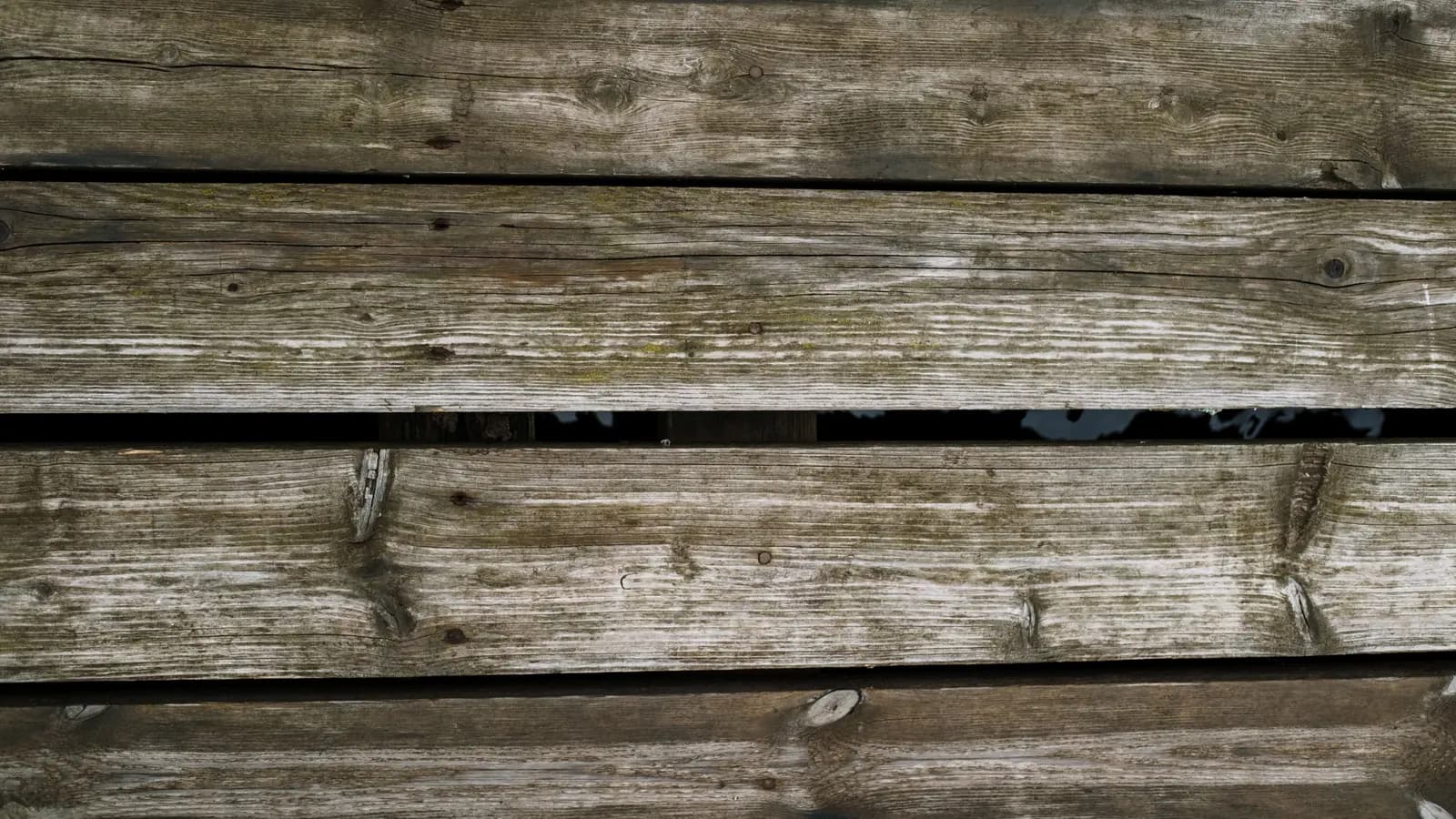 Close-up of weathered wooden deck boards with a natural aged texture.