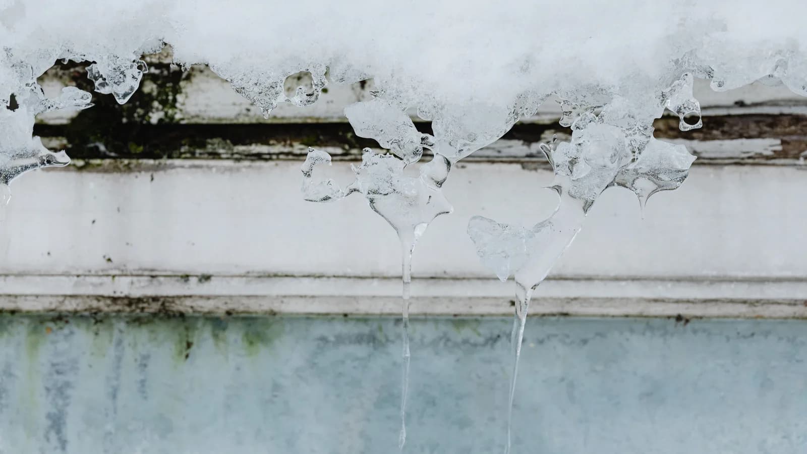 Detailed view of icicles hanging from a building in winter.