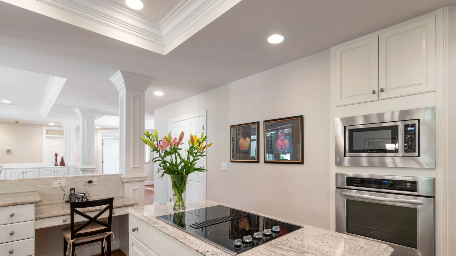 Spacious and elegant kitchen interior featuring granite countertops and built-in appliances.