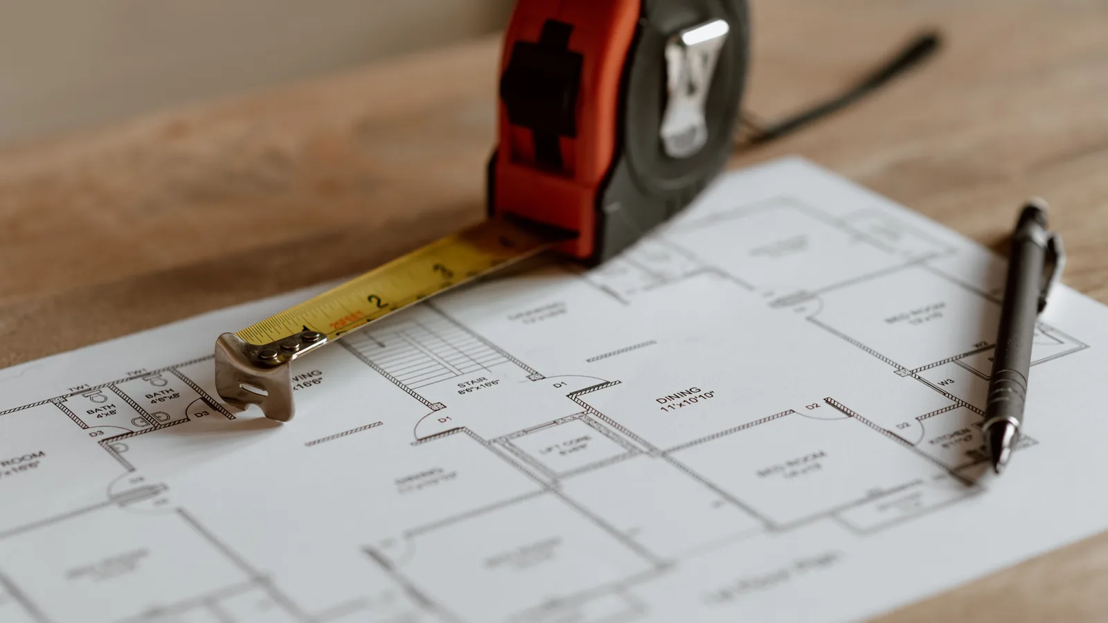From above of ruler placed near pencil on engineering plan of house during renovation process