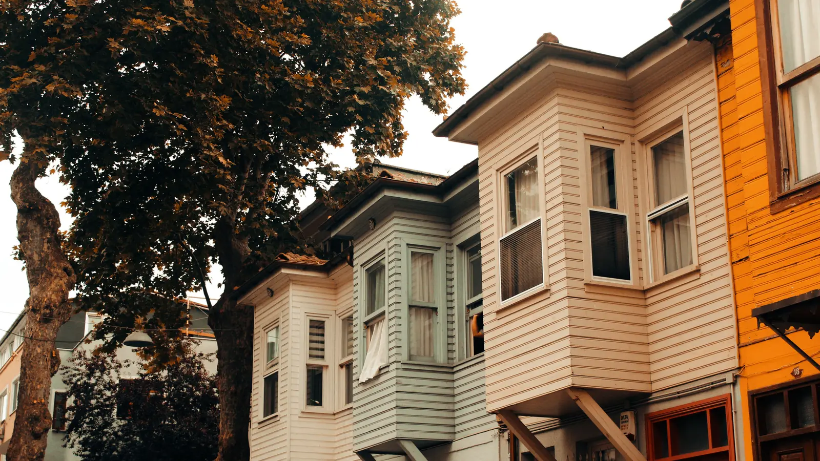 A picturesque view of colorful traditional houses lining a quiet urban street, embodying architectural charm.