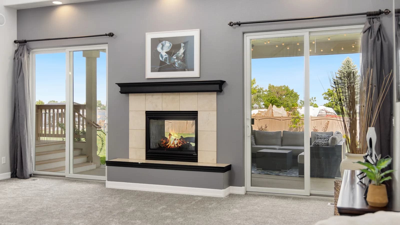 Two closed sliding glass door assemblies beside a fireplace