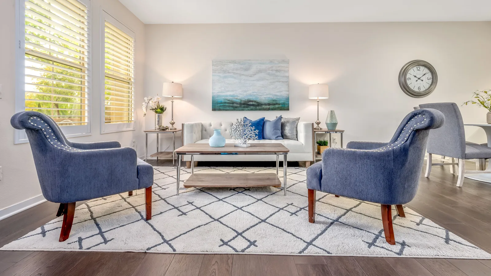 Living room seating group arranged with the front legs resting on a large area rug