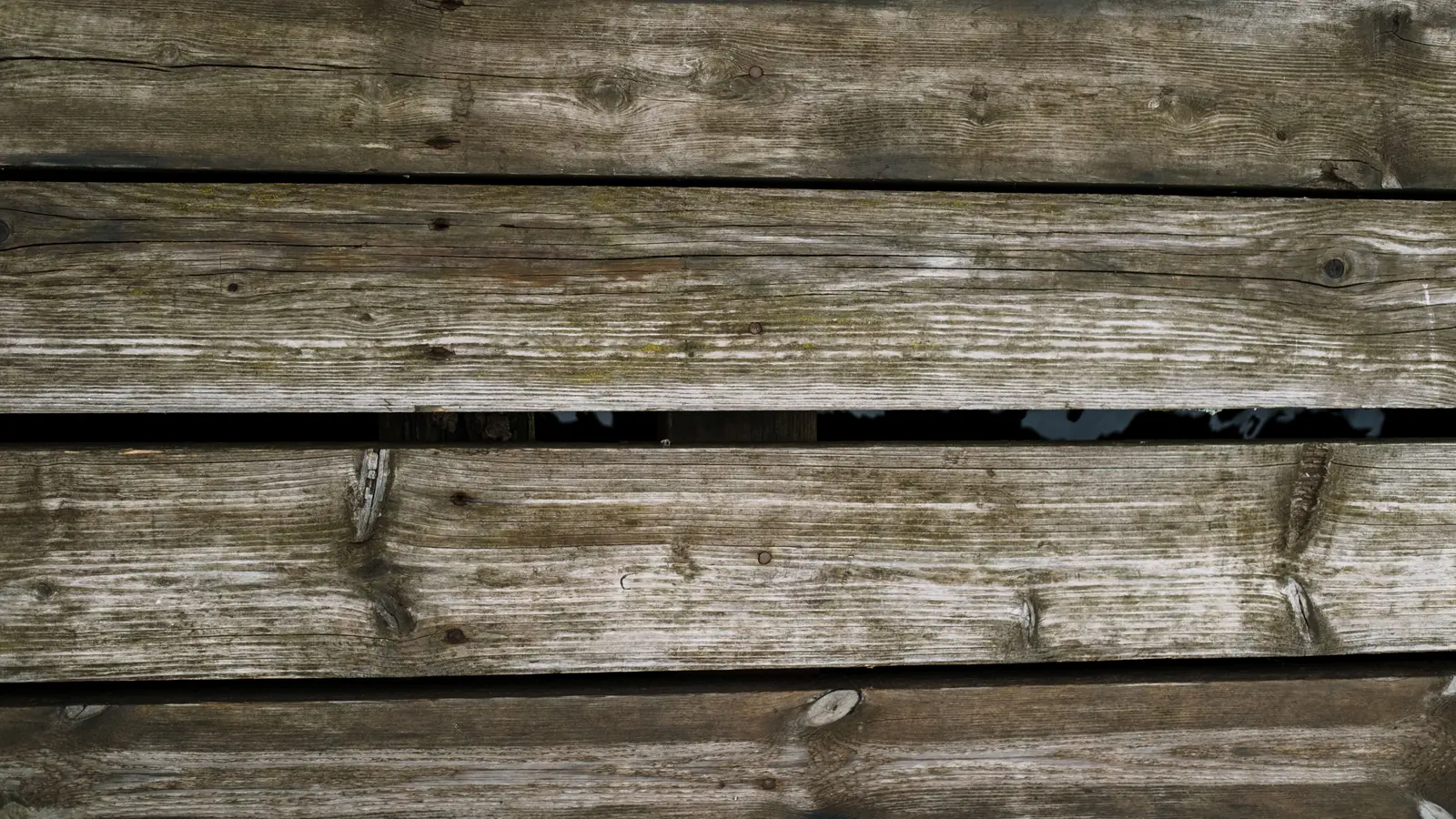 Close-up of weathered wooden deck boards with a natural aged texture.